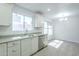 Bright eat-in kitchen with white cabinets, light countertops, and stainless appliances at 1450 E Topeka Dr, Phoenix, AZ 85024