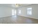 Open-concept living area with light wood floors, large windows and sliding glass door at 1450 E Topeka Dr, Phoenix, AZ 85024