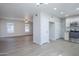 Open living space with light wood floors connecting to the kitchen area at 1450 E Topeka Dr, Phoenix, AZ 85024