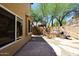 Backyard featuring stone patio, desert landscaping, exterior view of the house, and outdoor grill at 14833 S 14Th Pl, Phoenix, AZ 85048