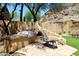 Backyard featuring stone patio, outdoor oven, landscaping, seating area, and barbecue grill at 14833 S 14Th Pl, Phoenix, AZ 85048