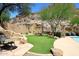 Backyard featuring stone patio, landscaping, seating area, grassy area, and view of the mountain at 14833 S 14Th Pl, Phoenix, AZ 85048