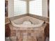 Close up on a luxurious soaking tub with dual sinks and granite countertops, and decorative tile floors at 14833 S 14Th Pl, Phoenix, AZ 85048