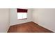 Clean bedroom with wood floors, window, and closet at 14833 S 14Th Pl, Phoenix, AZ 85048