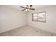Bright bedroom featuring neutral carpet, a ceiling fan, and window with horizontal blinds at 14833 S 14Th Pl, Phoenix, AZ 85048