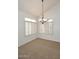 A bright and airy dining room with large windows, plantation shutters, and carpet flooring at 14833 S 14Th Pl, Phoenix, AZ 85048