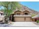Charming two-story home with a three-car garage, stone accents, and mountain views at 14833 S 14Th Pl, Phoenix, AZ 85048