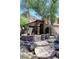 A well-kept home featuring a desert landscape with mature trees and a stone walkway at 14833 S 14Th Pl, Phoenix, AZ 85048
