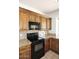 Close up on wooden cabinets, granite countertops, and black appliances in the kitchen at 14833 S 14Th Pl, Phoenix, AZ 85048