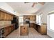 Spacious kitchen with wood cabinets, granite countertops, island, and modern black appliances at 14833 S 14Th Pl, Phoenix, AZ 85048