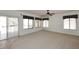 Open living room with carpet, sliding glass door, and many bright windows at 14833 S 14Th Pl, Phoenix, AZ 85048