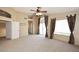 Open-concept living room with stylish curtains, a ceiling fan, and neutral carpet at 14833 S 14Th Pl, Phoenix, AZ 85048