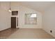 An open-concept living room with a high vaulted ceiling, large windows, and carpet flooring at 14833 S 14Th Pl, Phoenix, AZ 85048