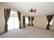 Spacious living room boasting large windows and sliding glass doors adorned with decorative curtains at 14833 S 14Th Pl, Phoenix, AZ 85048