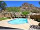 Backyard pool with mountain views, basketball hoop, desert landscaping, and well-manicured lawn at 14833 S 14Th Pl, Phoenix, AZ 85048