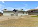 An expansive backyard features a concrete patio, desert landscaping, and block fence, ideal for outdoor entertaining at 1511 E Harmony Ave, Mesa, AZ 85204