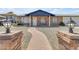 Inviting exterior featuring a brick facade, manicured landscaping, and a charming walkway at 1511 E Harmony Ave, Mesa, AZ 85204