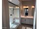 Modern bathroom featuring a glass shower door, white vanity, and updated fixtures at 15620 W Georgia Dr, Surprise, AZ 85379