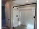 Shower with glass doors, a built in soap holder and light gray tile surround at 15620 W Georgia Dr, Surprise, AZ 85379