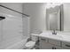 Bright bathroom featuring a shower-tub combo and a vanity with a sink and a white countertop at 15620 W Georgia Dr, Surprise, AZ 85379