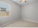 Empty bedroom featuring a ceiling fan, a window, carpet and light-grey paint at 15620 W Georgia Dr, Surprise, AZ 85379