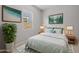 Tastefully decorated bedroom featuring stylish decor, lush greenery, and a comfortable queen bed at 15620 W Georgia Dr, Surprise, AZ 85379