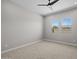 Empty bedroom with carpet, neutral walls, and dual windows to view the backyard at 15620 W Georgia Dr, Surprise, AZ 85379
