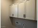 White upper cabinets in a utility room with brushed steel hardware at 15620 W Georgia Dr, Surprise, AZ 85379