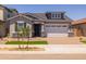 Charming single-Gathering home with a brick driveway, manicured lawn, and a two-car garage at 15620 W Georgia Dr, Surprise, AZ 85379