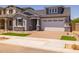 Charming single-Gathering home with a brick driveway, manicured lawn, and a two-car garage at 15620 W Georgia Dr, Surprise, AZ 85379