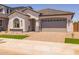 Charming single-story home with a manicured front yard, tile roof and a two car garage at 15620 W Georgia Dr, Surprise, AZ 85379