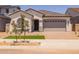 Charming single-story home with a manicured front yard, tile roof and a two car garage at 15620 W Georgia Dr, Surprise, AZ 85379
