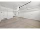 Spacious two car garage with white walls and concrete floor at 15620 W Georgia Dr, Surprise, AZ 85379