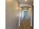 Arched hallway with hard wood flooring leading to other rooms in the house at 15620 W Georgia Dr, Surprise, AZ 85379
