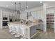 Bright kitchen features an island with bar seating, stainless appliances, granite countertops, and a walk-in pantry at 15620 W Georgia Dr, Surprise, AZ 85379