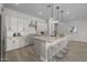 Bright kitchen features an island with seating, stainless appliances, and granite countertops at 15620 W Georgia Dr, Surprise, AZ 85379