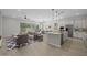 Spacious open concept with kitchen island, dining area, and a living room with modern finishes at 15620 W Georgia Dr, Surprise, AZ 85379