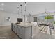 Open floor plan with a kitchen island, stainless steel appliances, and a dining area at 15620 W Georgia Dr, Surprise, AZ 85379