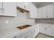 New kitchen features white cabinets, subway tile and quartz countertop at 15620 W Georgia Dr, Surprise, AZ 85379