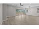 Bright, unfurnished living room with hardwood floors, a ceiling fan, and sliding glass doors at 15620 W Georgia Dr, Surprise, AZ 85379