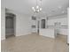 Open floor plan with tile floors, archways, and a kitchen island with bar seating at 15620 W Georgia Dr, Surprise, AZ 85379