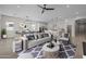 Spacious open-concept living space, seamlessly flowing into the kitchen and dining areas, fully furnished at 15620 W Georgia Dr, Surprise, AZ 85379