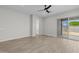 Bright, unfurnished living room with hardwood floors, a ceiling fan, and sliding glass doors at 15620 W Georgia Dr, Surprise, AZ 85379