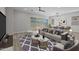 Bright living room with hardwood floors, a ceiling fan, sliding glass doors, and modern furniture at 15620 W Georgia Dr, Surprise, AZ 85379