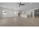 Spacious unfurnished open-concept living space, seamlessly flowing into the kitchen and dining areas at 15620 W Georgia Dr, Surprise, AZ 85379