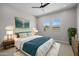 Comfortable main bedroom with a ceiling fan, dual windows and stylish decor at 15620 W Georgia Dr, Surprise, AZ 85379