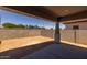 Covered patio overlooking the spacious backyard with privacy wall at 15620 W Georgia Dr, Surprise, AZ 85379