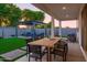 Backyard with manicured lawn, modern patio furniture, pergola, and alfresco dining area at 15695 W Christy Dr, Surprise, AZ 85379