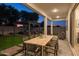 Expansive backyard patio with outdoor dining, custom pergola and stylish seating, perfect for entertaining at 15695 W Christy Dr, Surprise, AZ 85379