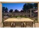 Beautiful backyard patio with outdoor dining, custom pergola, stylish seating, lush turf and hardscape at 15695 W Christy Dr, Surprise, AZ 85379